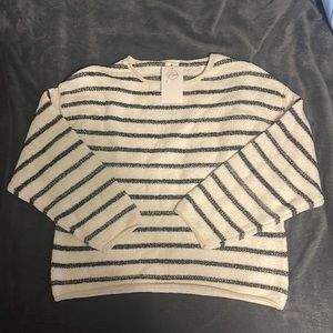 White sweater with navy blue stripes.